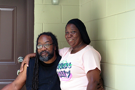 PASF couple outside renovated home