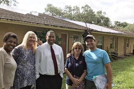 Center for Multi-Cultural Wellness and Prevention staff in front of the supportive housing facility to be renovated.